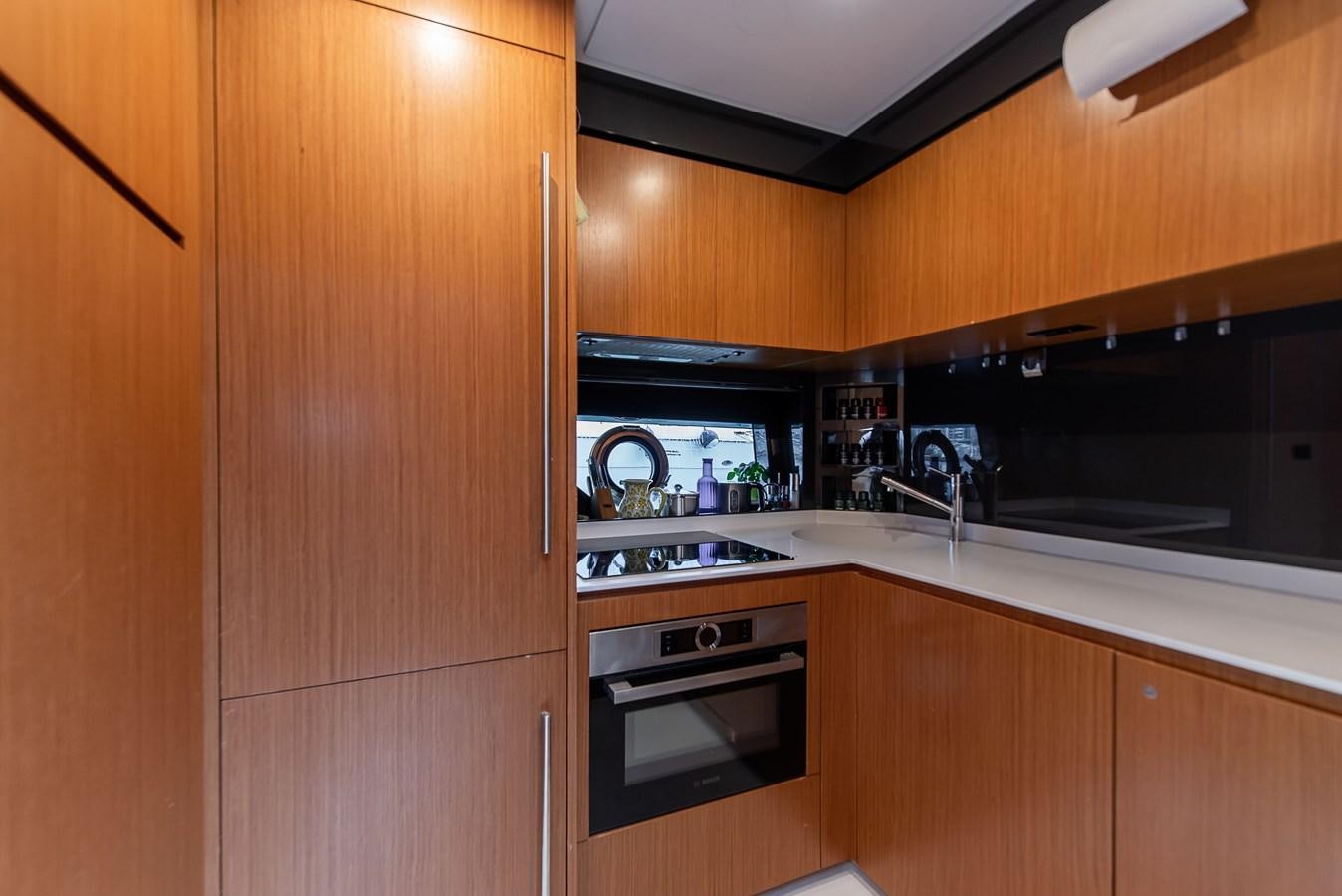 a kitchen with wooden cabinets aboard SOUL Yacht for Sale