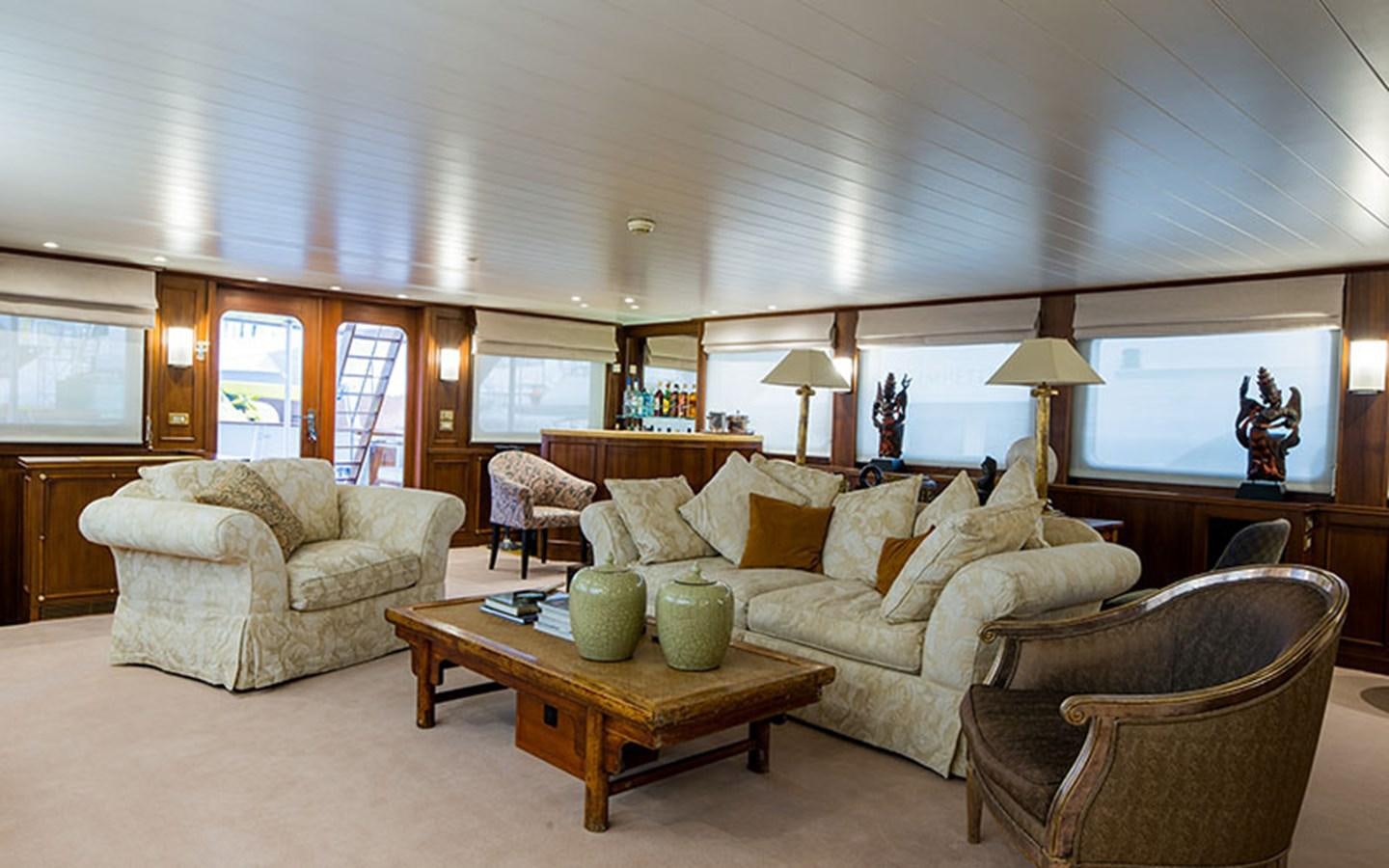 a living room with a couch and a coffee table aboard NOSTALGIA Yacht for Sale