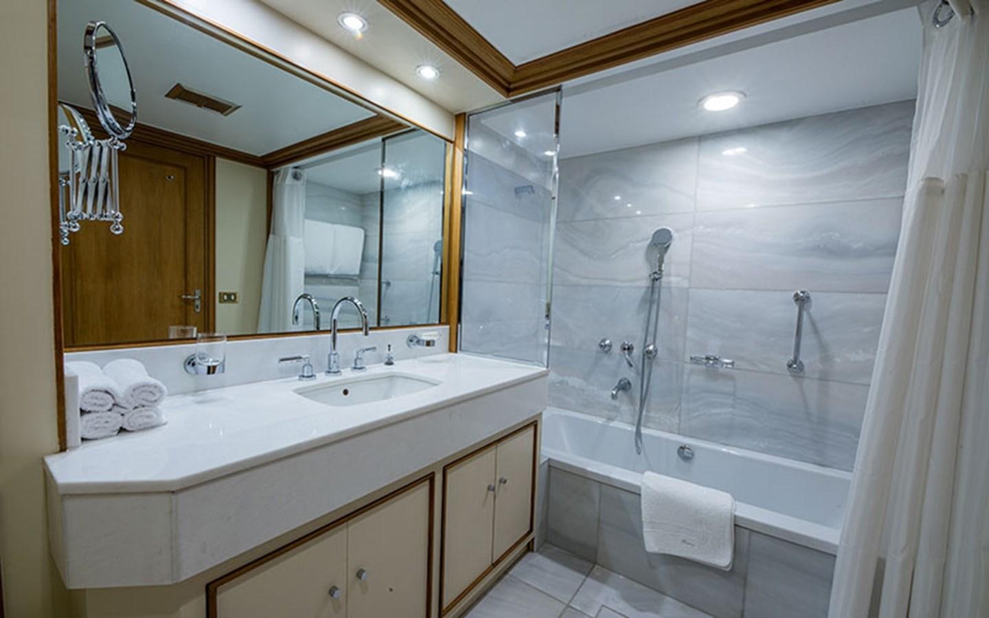 a bathroom with a large mirror aboard NOSTALGIA Yacht for Sale