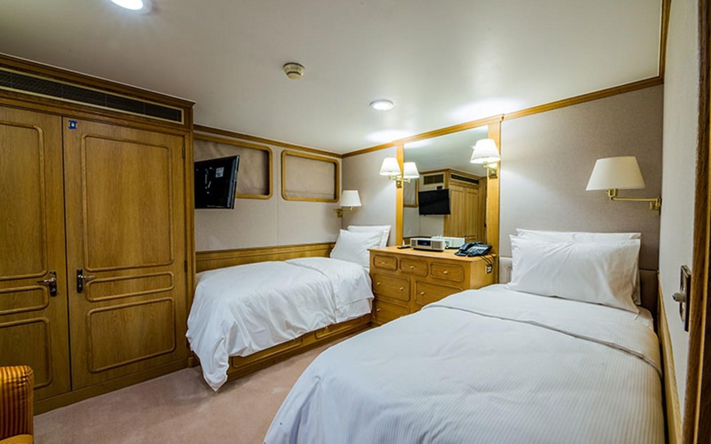 a hotel room with two beds aboard NOSTALGIA Yacht for Sale