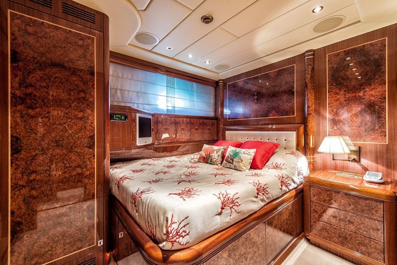 a bedroom with a bed and a window aboard PHANTOM Yacht for Sale