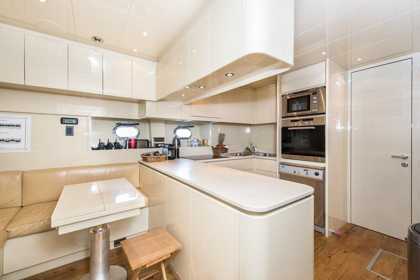 a kitchen with white cabinets aboard PHANTOM Yacht for Sale
