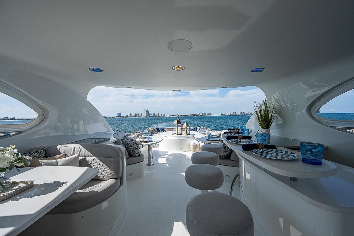 a room with a view of the ocean and a city aboard LAZZARA 116 OPEN BRIDGE Yacht for Sale