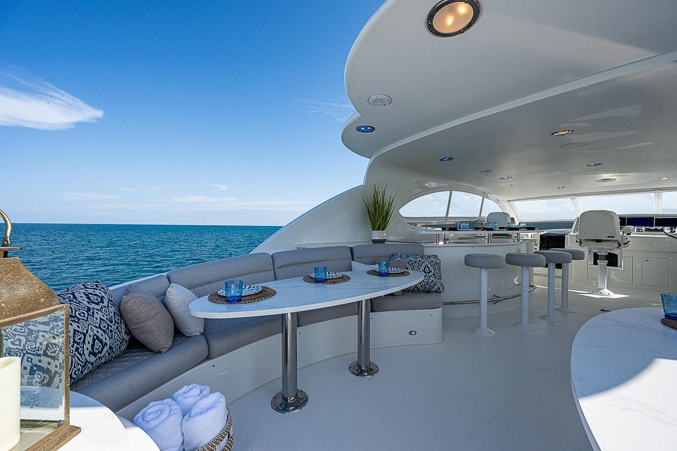 a room with a table and chairs aboard LAZZARA 116 OPEN BRIDGE Yacht for Sale