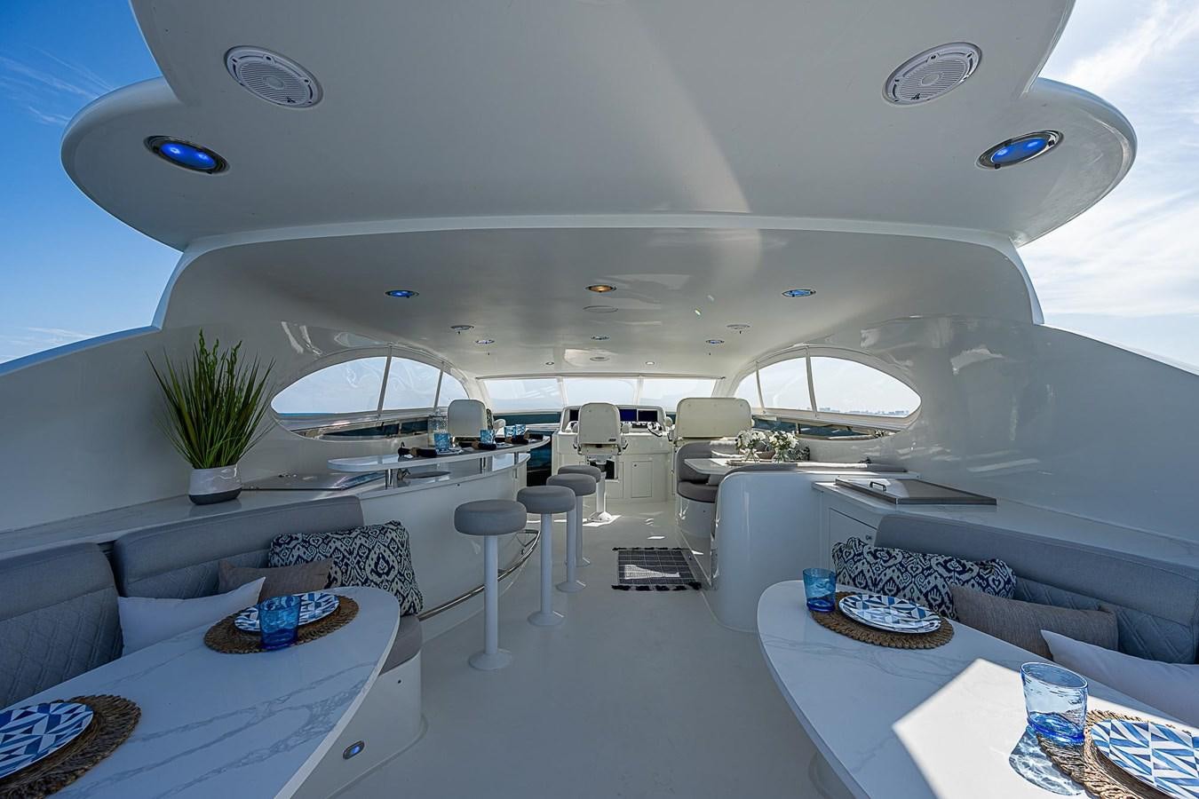 inside of a room with a couch and a table with chairs aboard LAZZARA 116 OPEN BRIDGE Yacht for Sale
