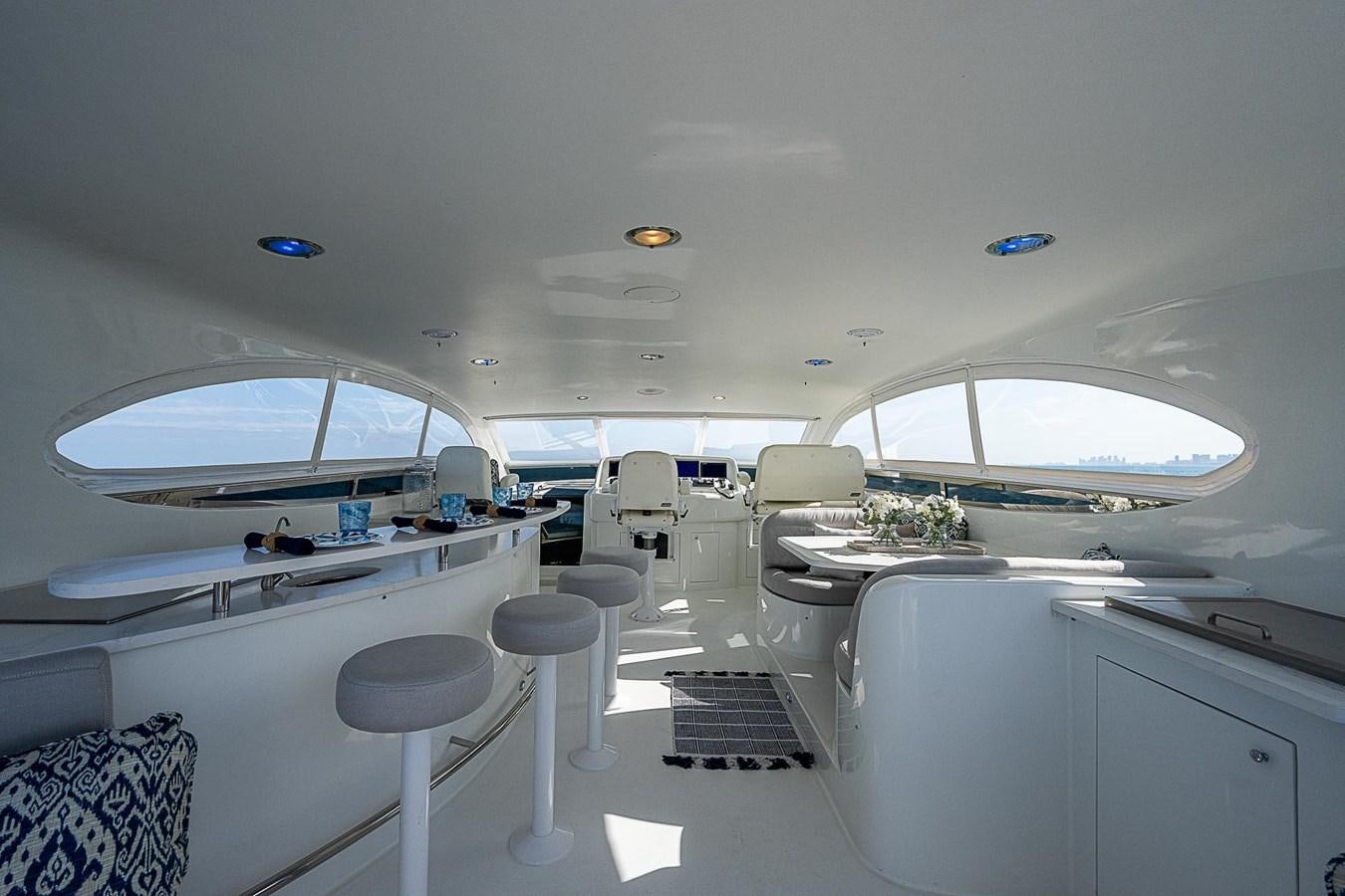 a room with a table and chairs aboard LAZZARA 116 OPEN BRIDGE Yacht for Sale