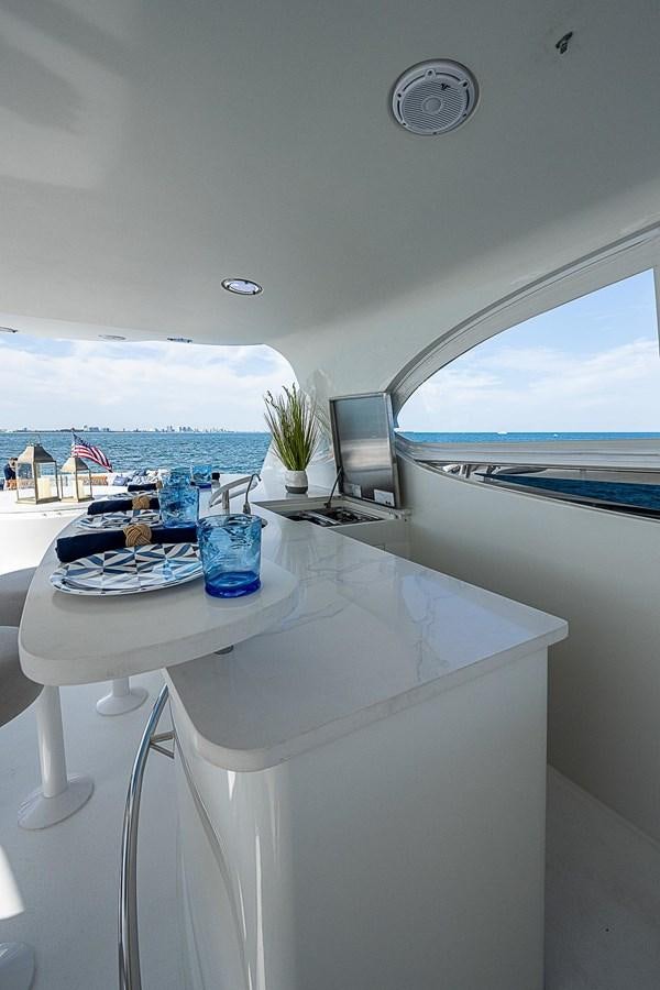 a table with a laptop on it aboard LAZZARA 116 OPEN BRIDGE Yacht for Sale