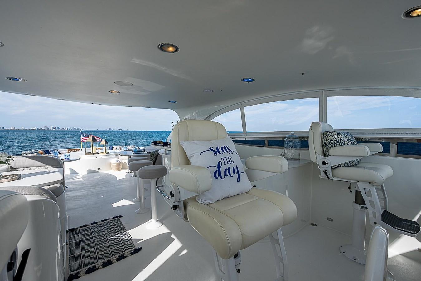 a plane with chairs and a table aboard LAZZARA 116 OPEN BRIDGE Yacht for Sale
