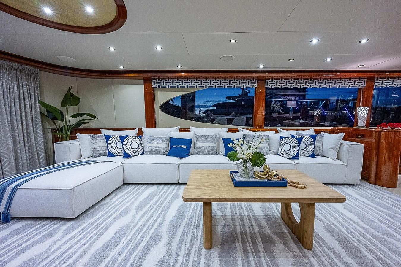 a room with a couch and a table aboard LAZZARA 116 OPEN BRIDGE Yacht for Sale