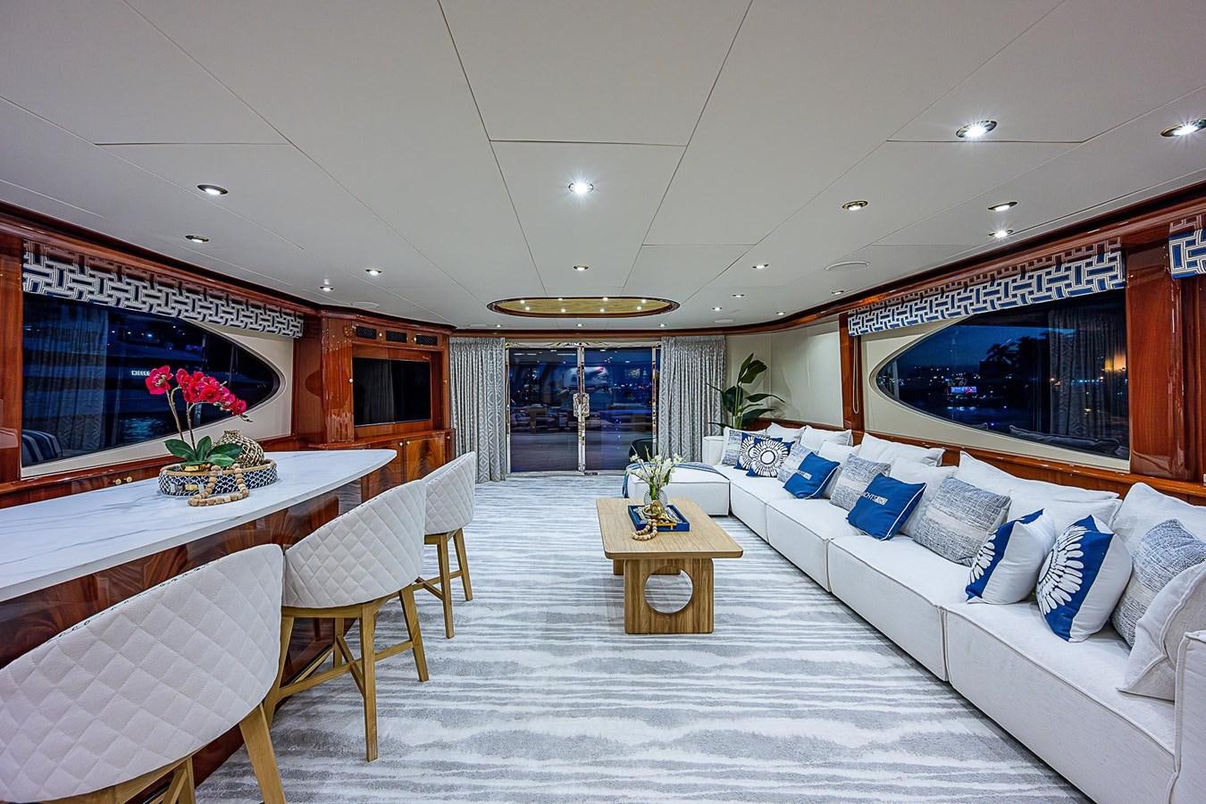 a room with a bed and a table and chairs aboard LAZZARA 116 OPEN BRIDGE Yacht for Sale