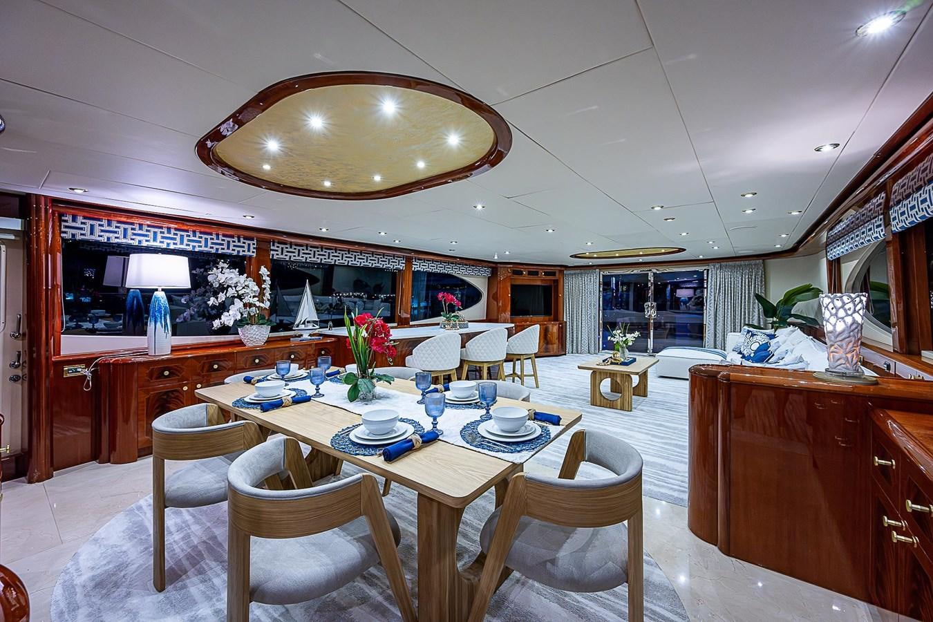 a dining room with a table and chairs aboard LAZZARA 116 OPEN BRIDGE Yacht for Sale