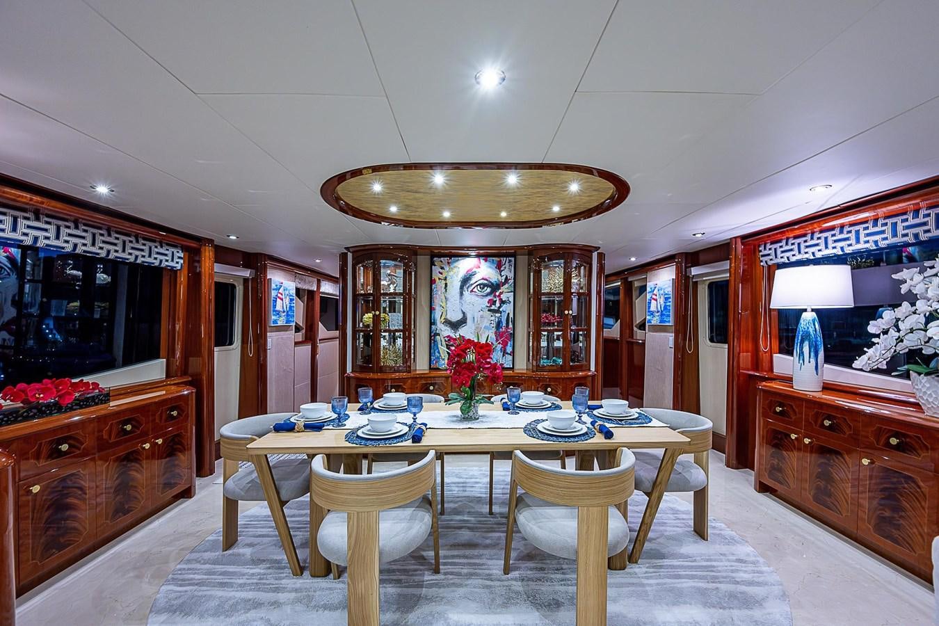 a dining room with a table and chairs aboard LAZZARA 116 OPEN BRIDGE Yacht for Sale