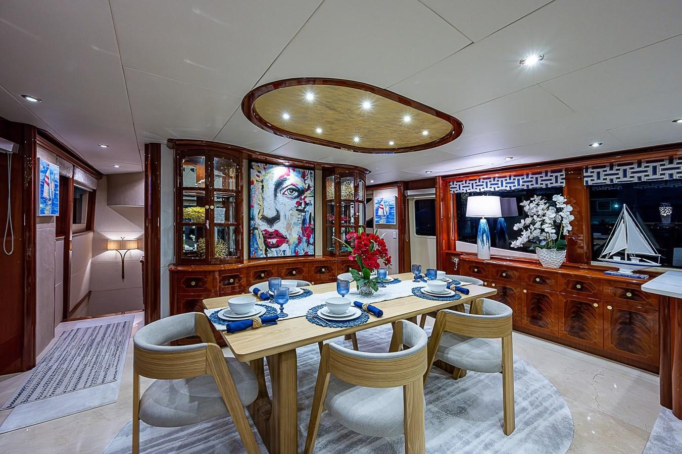 a dining room with a table and chairs aboard LAZZARA 116 OPEN BRIDGE Yacht for Sale