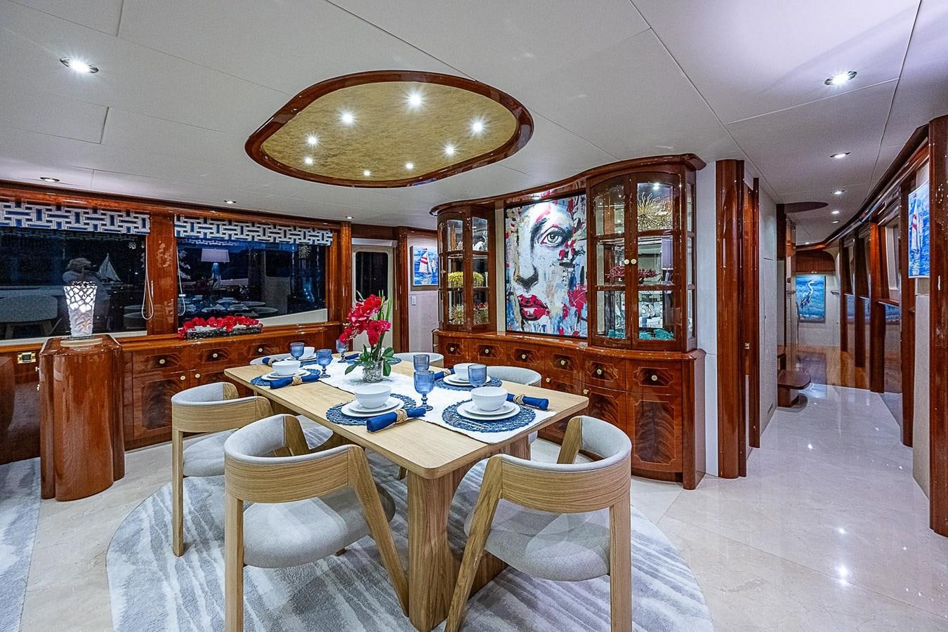 a dining room with a table and chairs aboard LAZZARA 116 OPEN BRIDGE Yacht for Sale