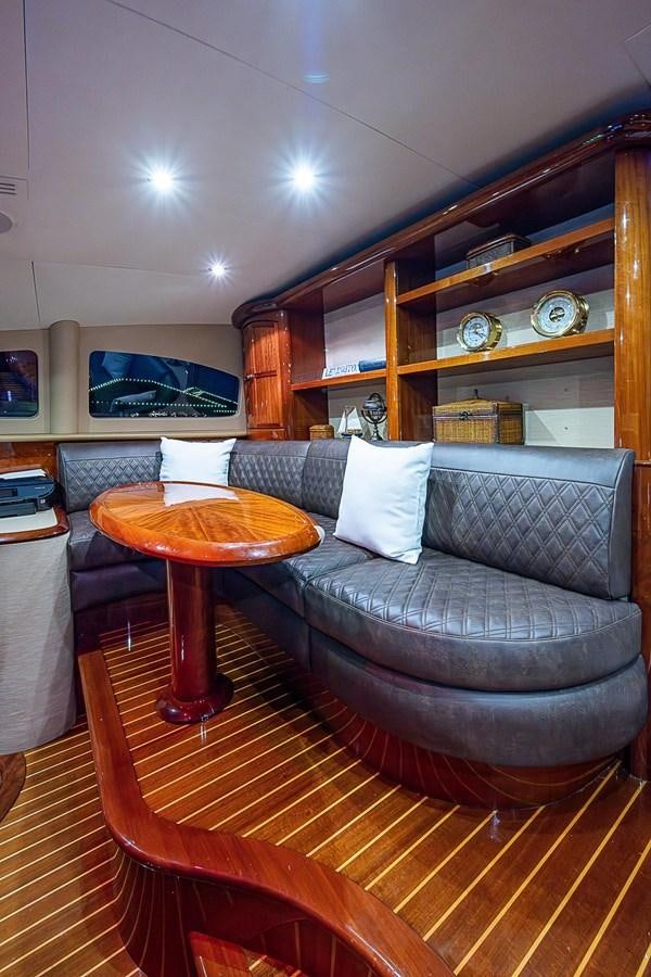 a living room with a couch and a coffee table aboard LAZZARA 116 OPEN BRIDGE Yacht for Sale