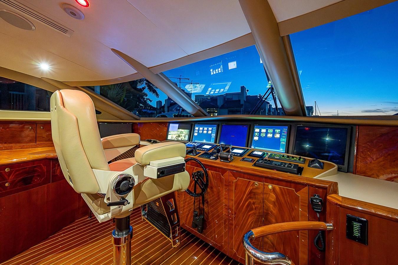 a room with a desk and chairs aboard LAZZARA 116 OPEN BRIDGE Yacht for Sale