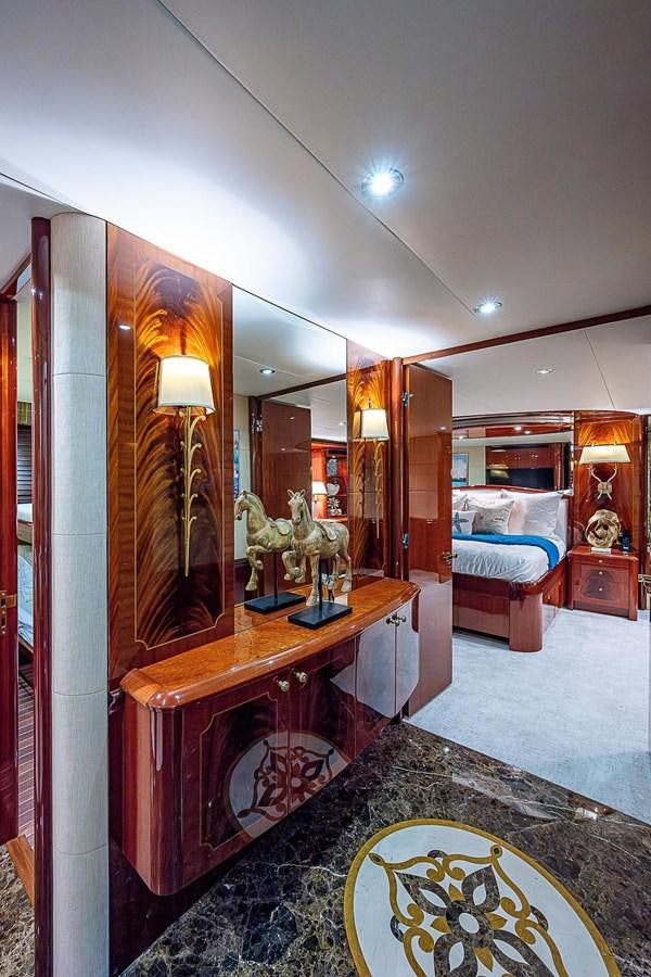 a bathroom with a vanity mirror and a rug aboard LAZZARA 116 OPEN BRIDGE Yacht for Sale