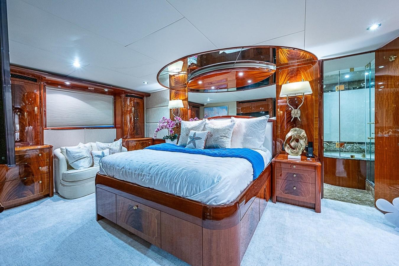 a bedroom with a bed and a mirror aboard LAZZARA 116 OPEN BRIDGE Yacht for Sale