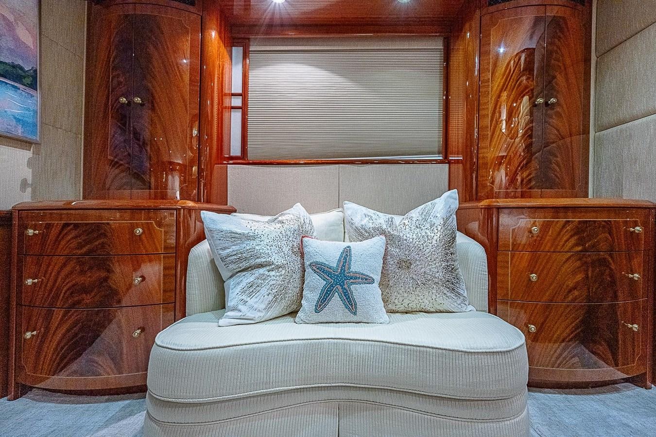 a white couch with pillows aboard LAZZARA 116 OPEN BRIDGE Yacht for Sale