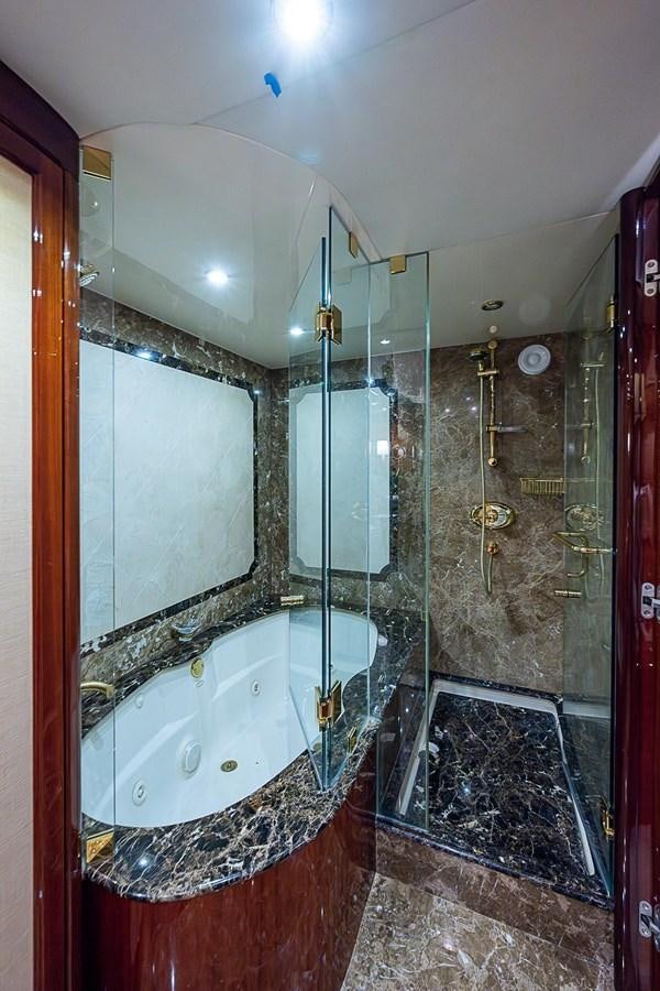 a bathroom with a glass shower aboard LAZZARA 116 OPEN BRIDGE Yacht for Sale