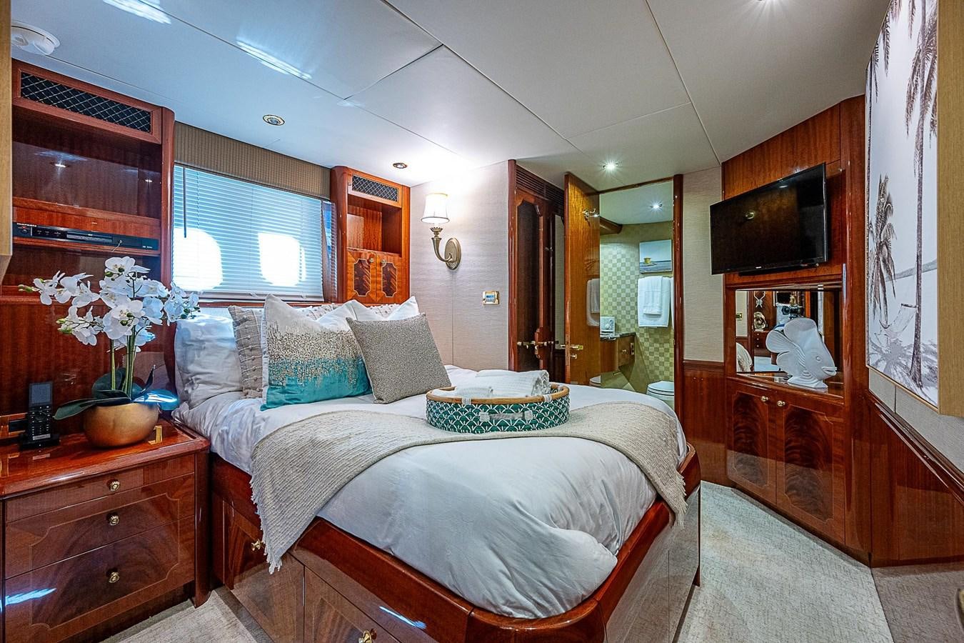a bedroom with a bed and a television aboard LAZZARA 116 OPEN BRIDGE Yacht for Sale