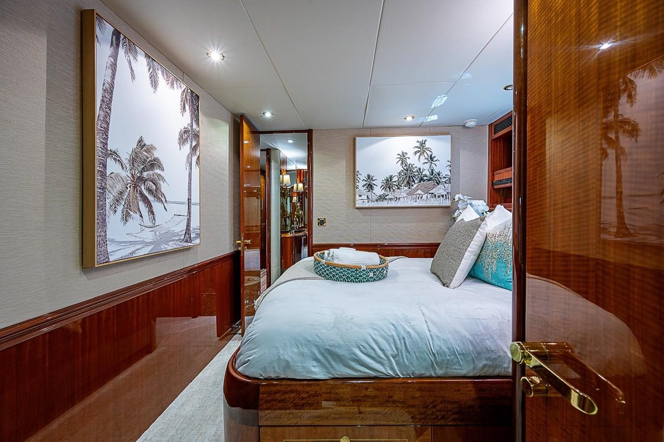 a bedroom with a bed and paintings aboard LAZZARA 116 OPEN BRIDGE Yacht for Sale