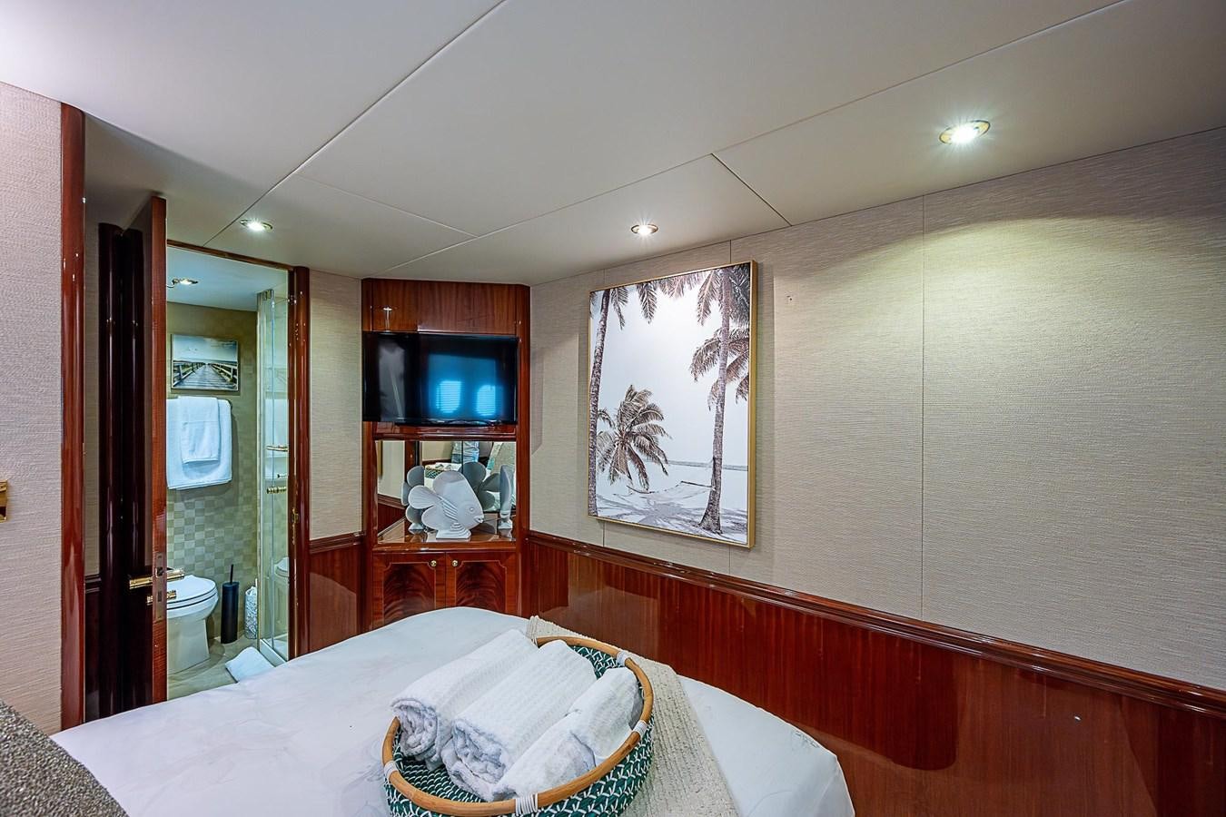 a bedroom with a bed and a television aboard LAZZARA 116 OPEN BRIDGE Yacht for Sale