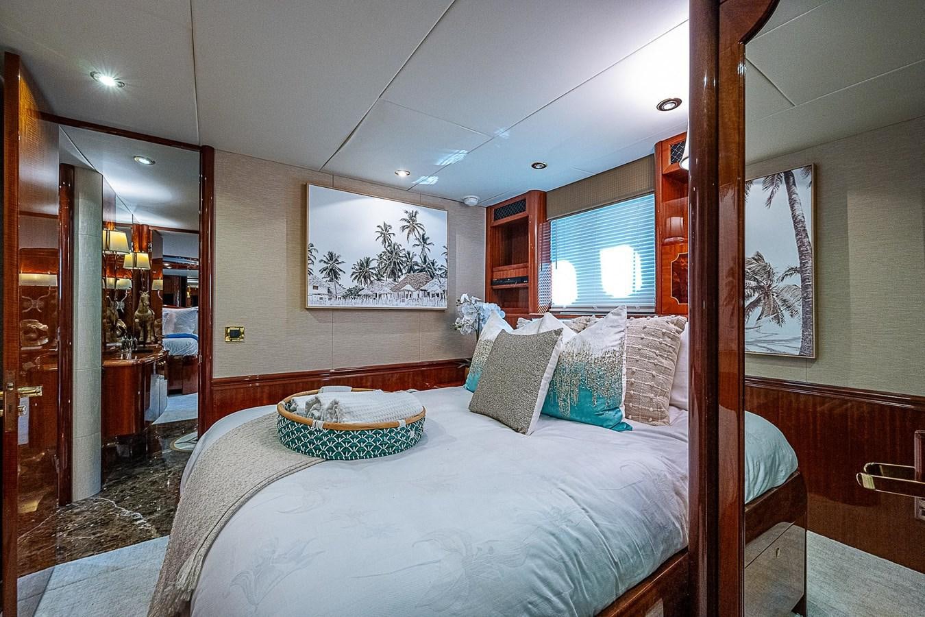 a bedroom with a bed and a mirror aboard LAZZARA 116 OPEN BRIDGE Yacht for Sale