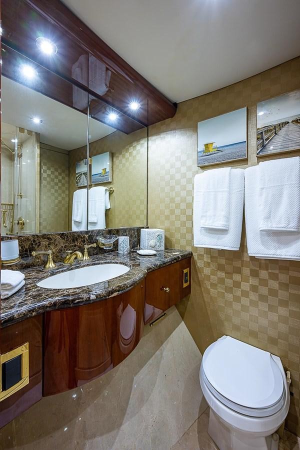 a bathroom with a sink and a toilet aboard LAZZARA 116 OPEN BRIDGE Yacht for Sale
