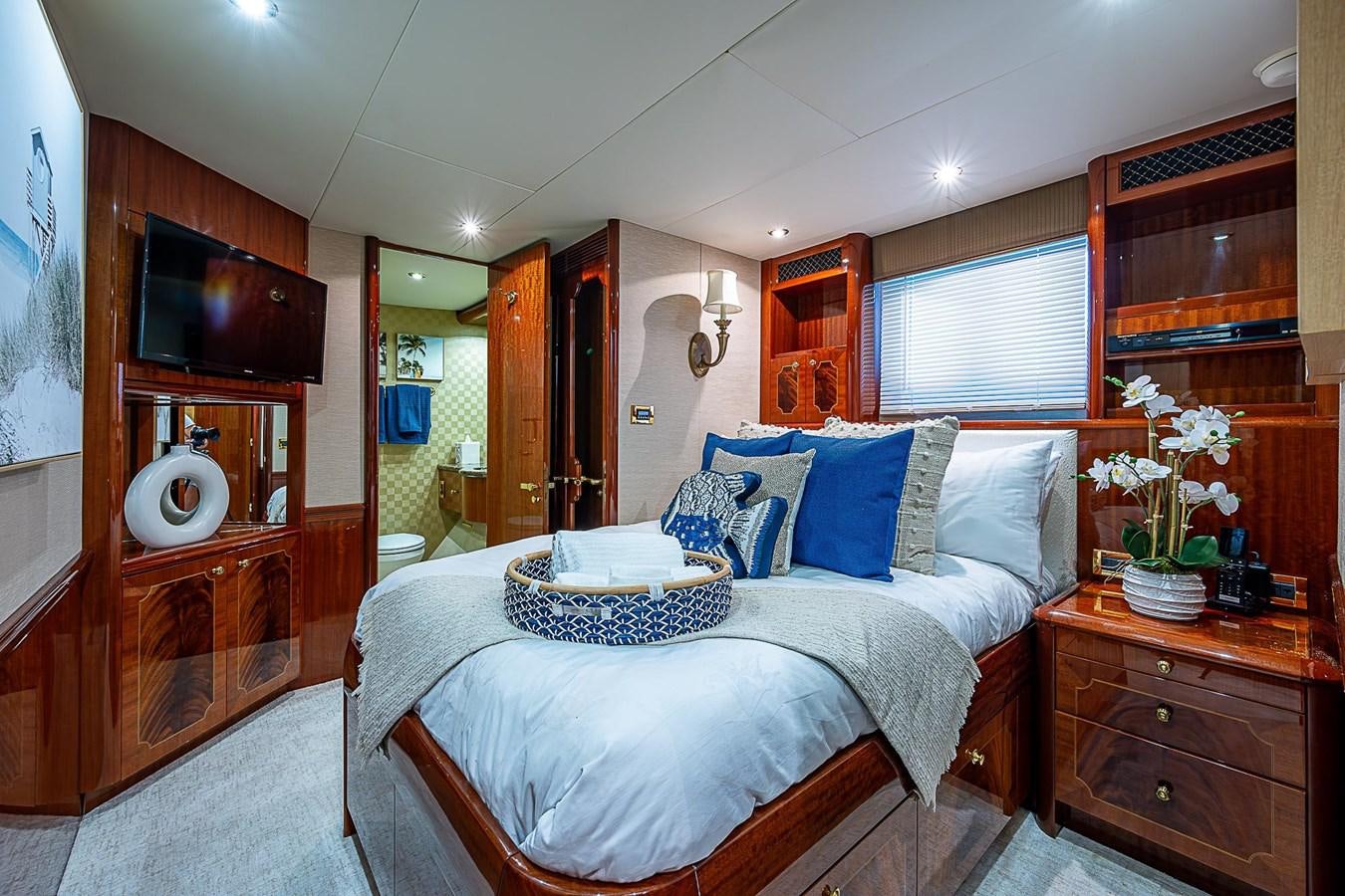 a bedroom with a bed and a television aboard LAZZARA 116 OPEN BRIDGE Yacht for Sale