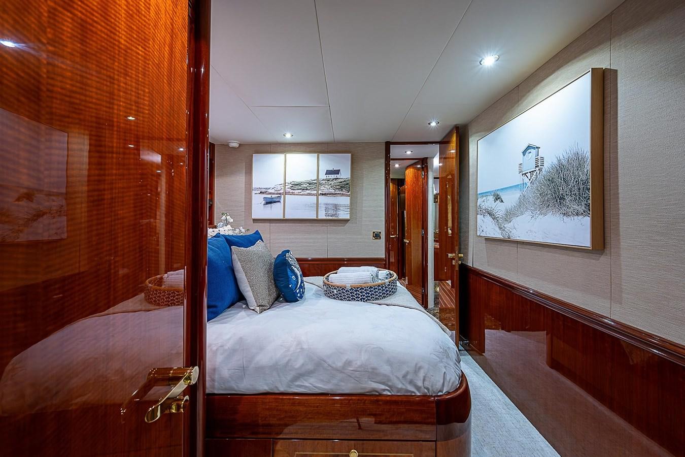 a bedroom with a bed and a mirror aboard LAZZARA 116 OPEN BRIDGE Yacht for Sale