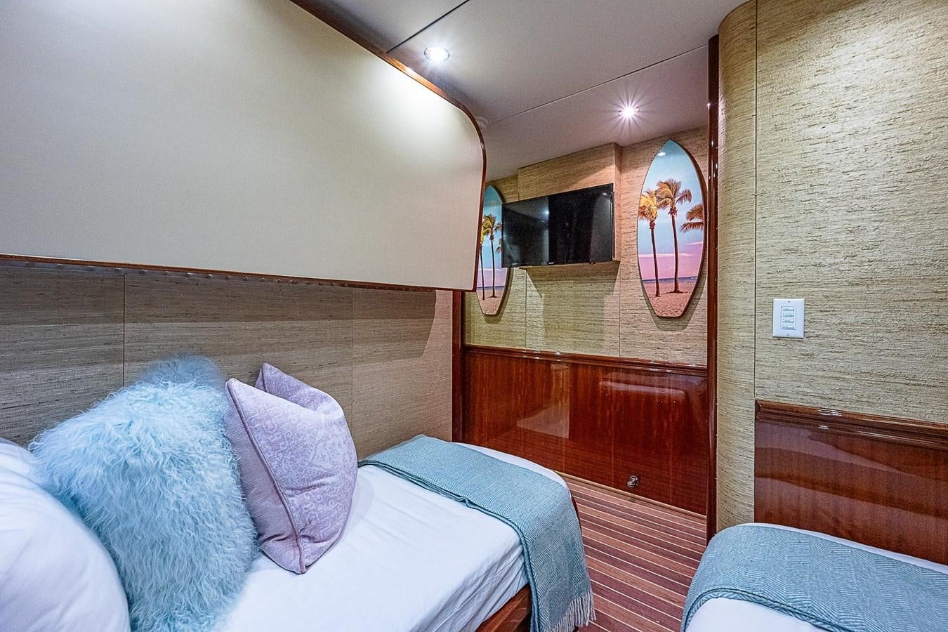 a room with a bed and a television aboard LAZZARA 116 OPEN BRIDGE Yacht for Sale