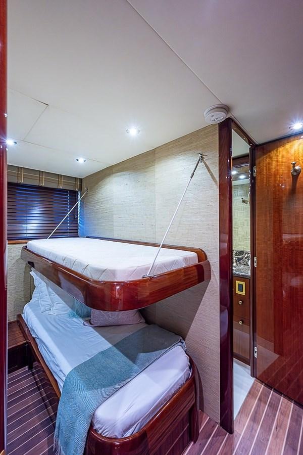 a room with a bed and a door aboard LAZZARA 116 OPEN BRIDGE Yacht for Sale