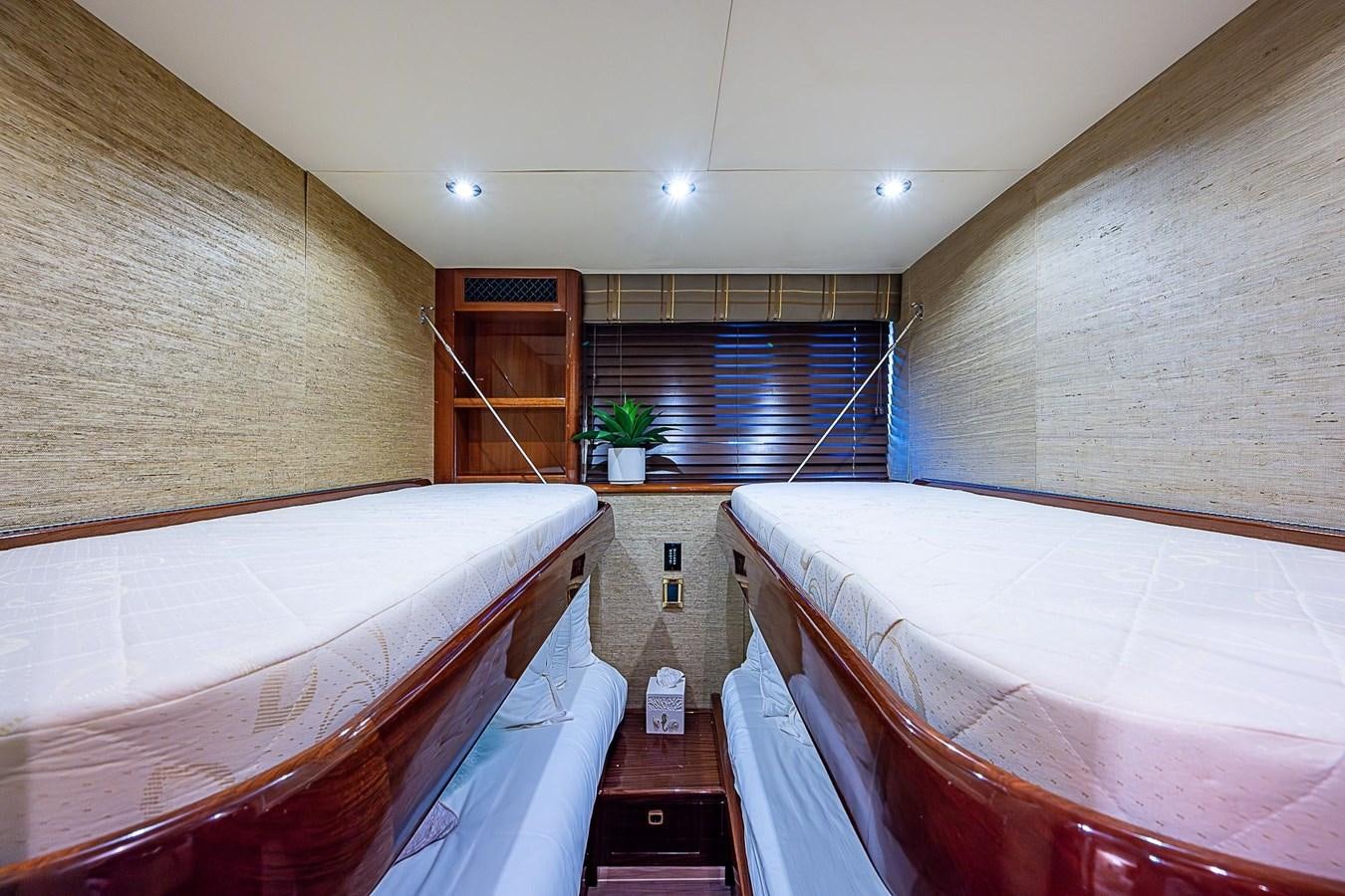 a room with a couple of beds aboard LAZZARA 116 OPEN BRIDGE Yacht for Sale