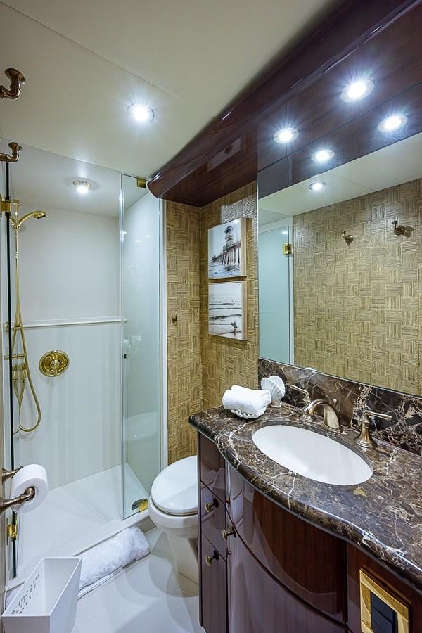 a bathroom with a sink and a shower aboard LAZZARA 116 OPEN BRIDGE Yacht for Sale