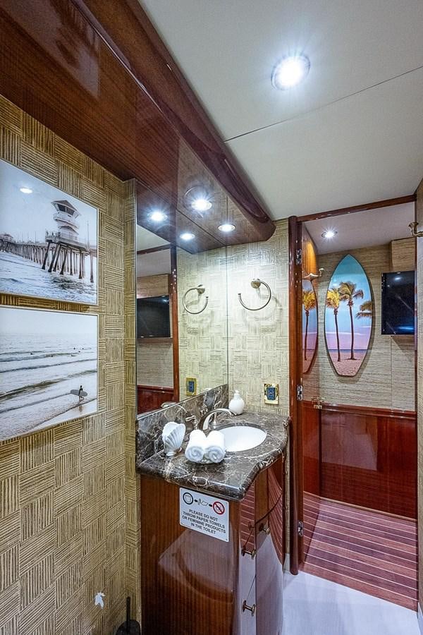 a bathroom with a sink and a mirror aboard LAZZARA 116 OPEN BRIDGE Yacht for Sale