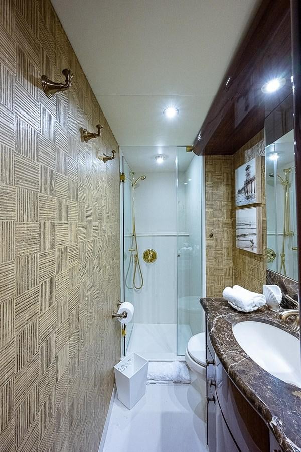a bathroom with a shower and sink aboard LAZZARA 116 OPEN BRIDGE Yacht for Sale