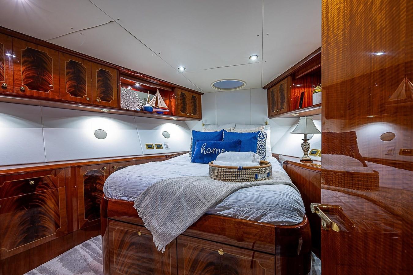 a bedroom with a bed and a table aboard LAZZARA 116 OPEN BRIDGE Yacht for Sale