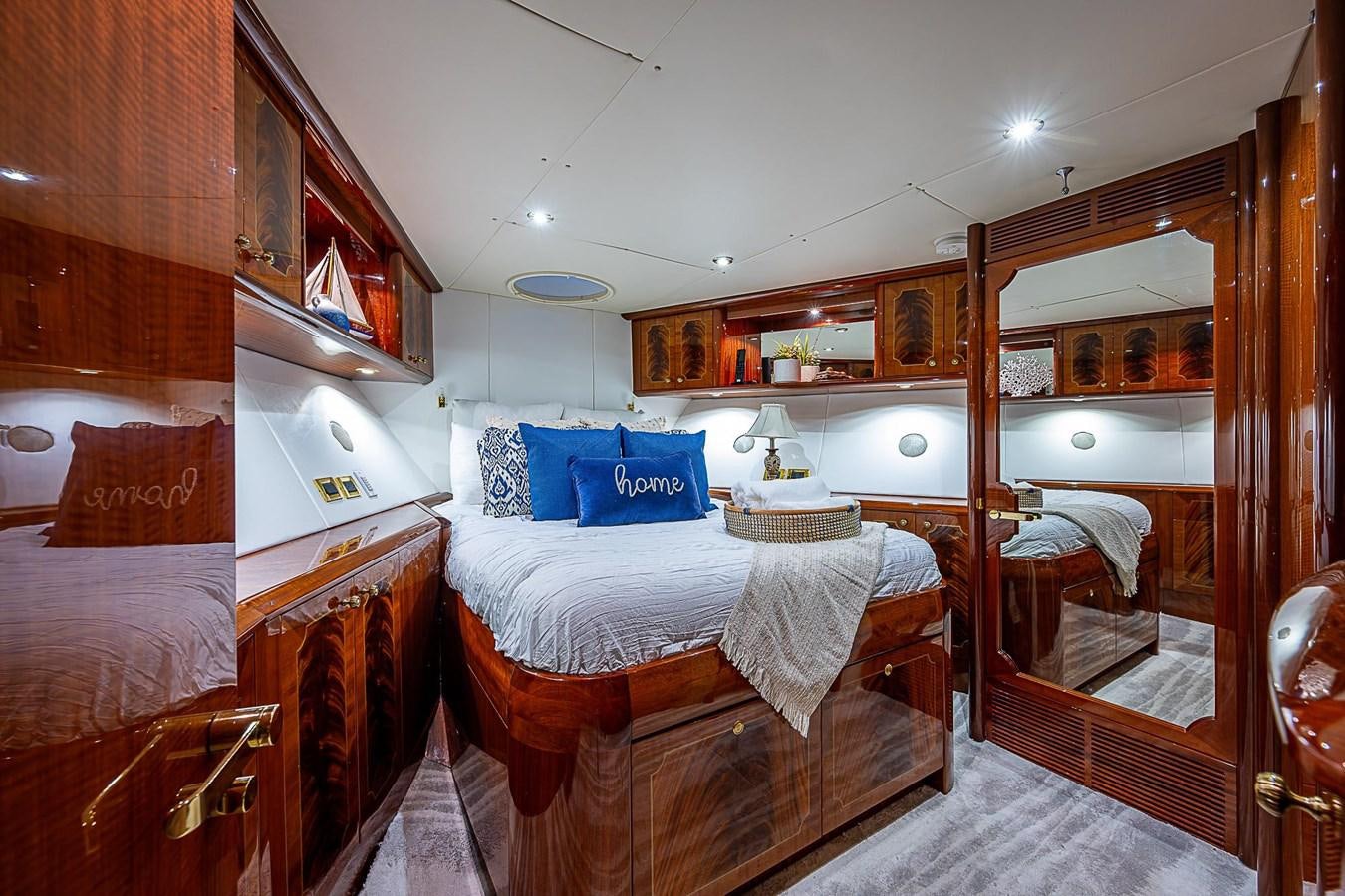 a room with a bed and a mirror aboard LAZZARA 116 OPEN BRIDGE Yacht for Sale