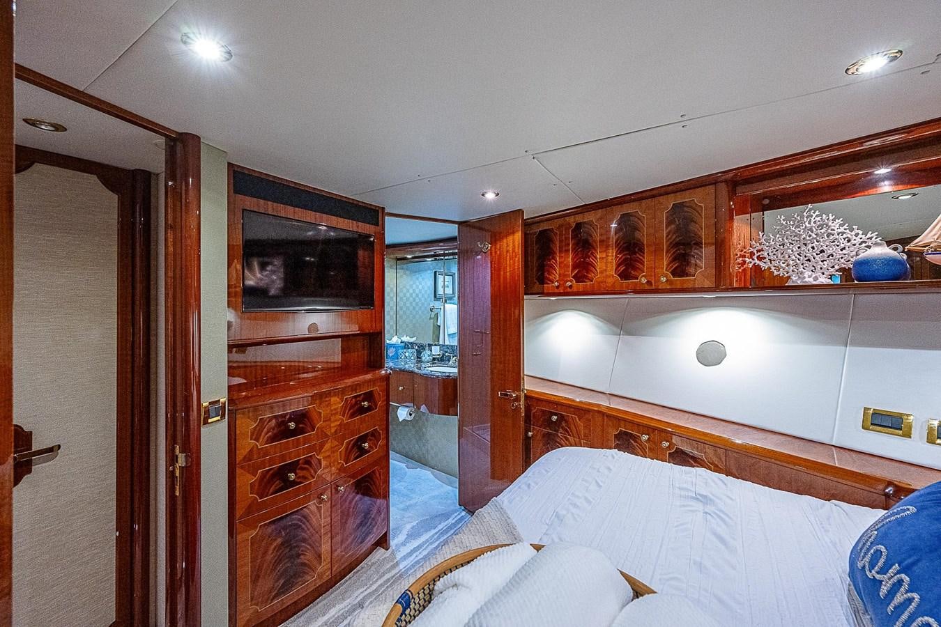 a bedroom with a bed and a television aboard LAZZARA 116 OPEN BRIDGE Yacht for Sale