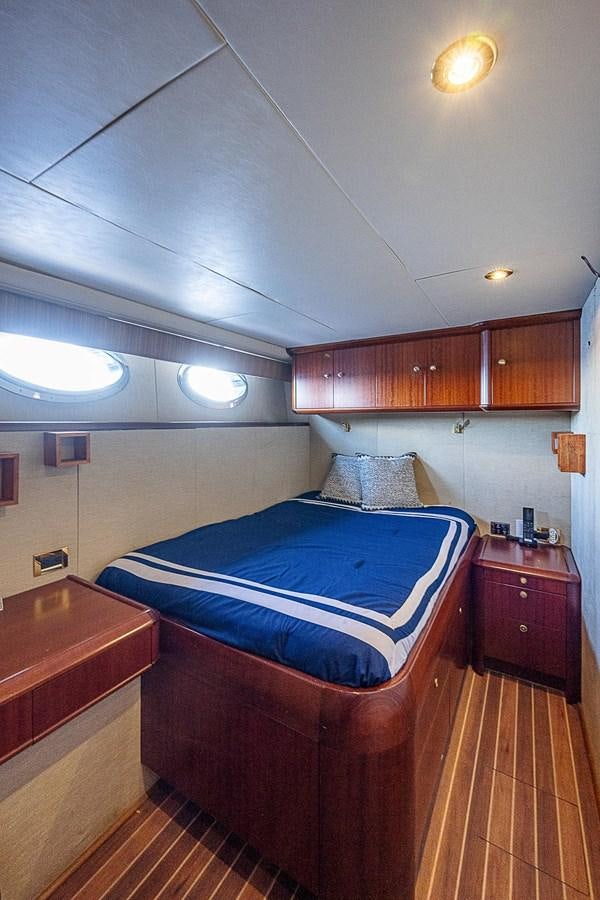 a bedroom with a bed and a desk aboard LAZZARA 116 OPEN BRIDGE Yacht for Sale