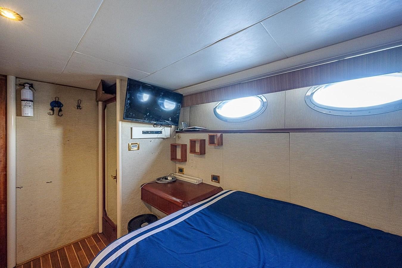 a bedroom with a blue bed aboard LAZZARA 116 OPEN BRIDGE Yacht for Sale