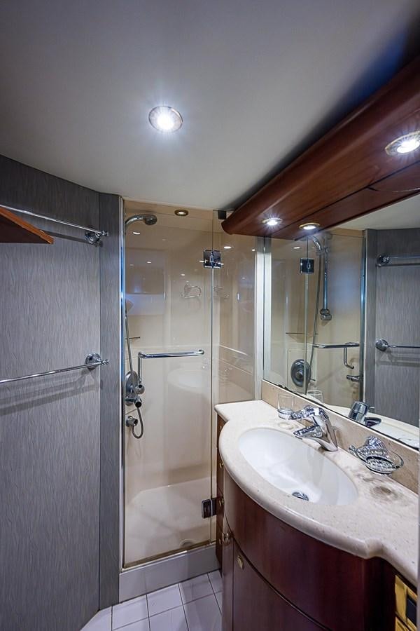 a bathroom with a shower and sink aboard LAZZARA 116 OPEN BRIDGE Yacht for Sale