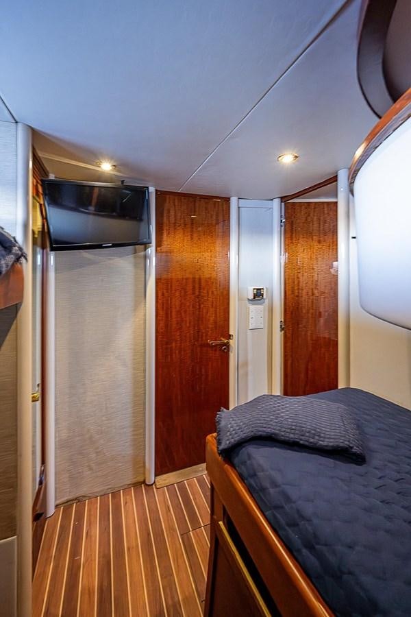 a bed and a closet in a room aboard LAZZARA 116 OPEN BRIDGE Yacht for Sale