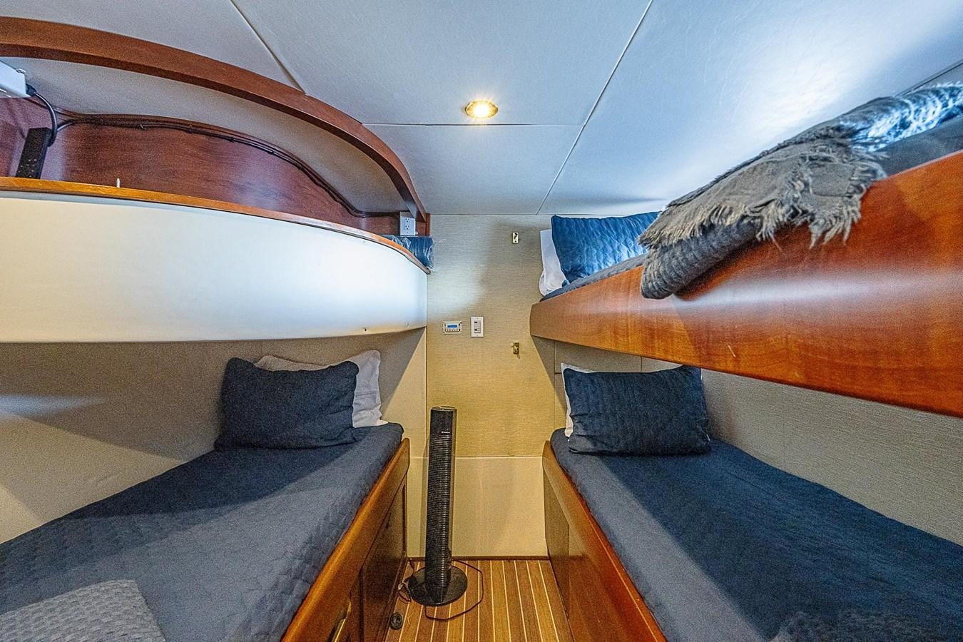 a room with bunk beds aboard LAZZARA 116 OPEN BRIDGE Yacht for Sale