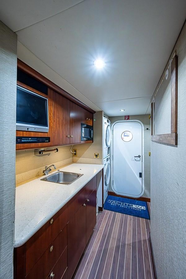 a kitchen with a sink and microwave aboard LAZZARA 116 OPEN BRIDGE Yacht for Sale