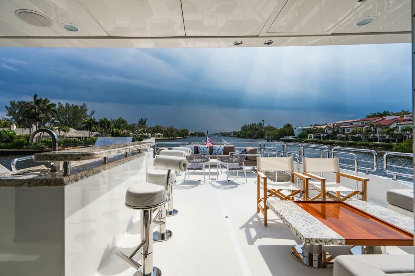 a room with tables and chairs aboard NEW ARRIVAL Yacht for Sale