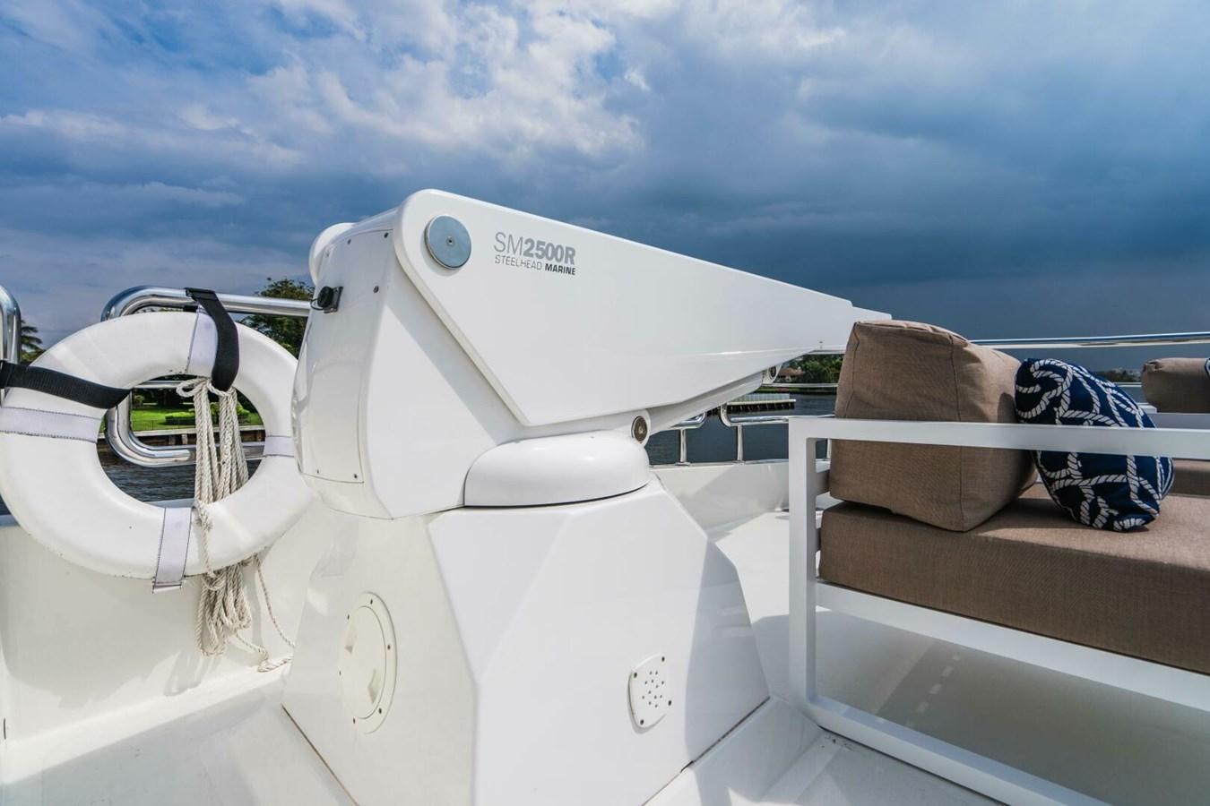a white boat with a brown object on the front aboard NEW ARRIVAL Yacht for Sale