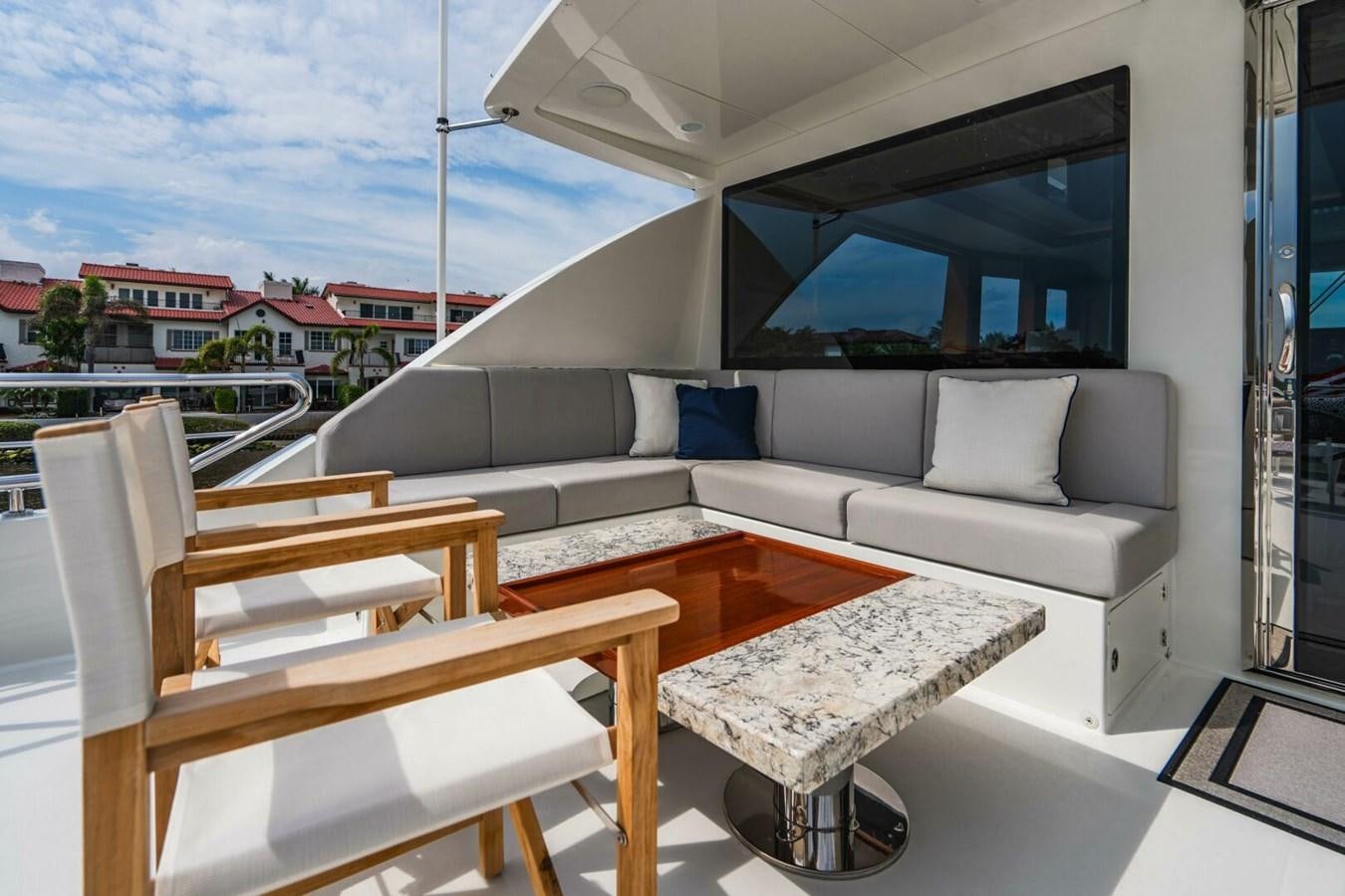 a room with a couch and a table and a window aboard NEW ARRIVAL Yacht for Sale