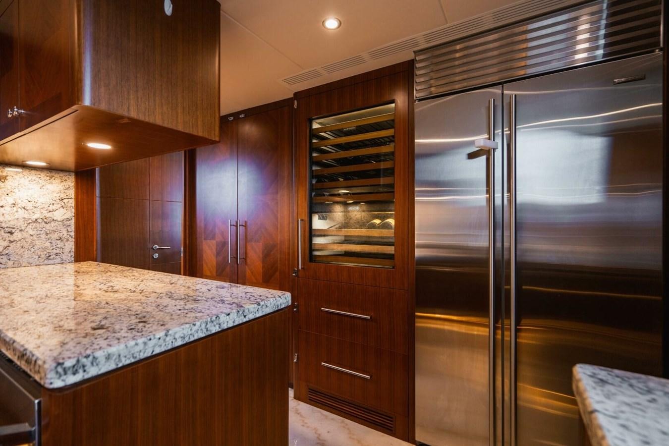 a kitchen with a stainless steel refrigerator aboard NEW ARRIVAL Yacht for Sale